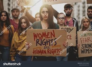 stock-photo-group-of-young-people-demonstration-for-women-s-rights-gen-z-students-marching-showing-english-2121333602.jpg